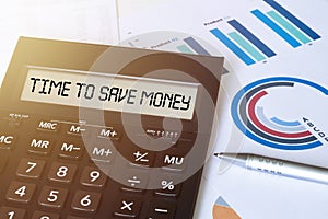 Word TIME TO SAVE MONEY on calculator. Business and finance concept