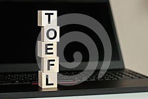 The word TOEFL in wooden cubes on the keyboard