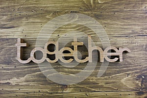 The word ` TOGETHER` over the wooden board.