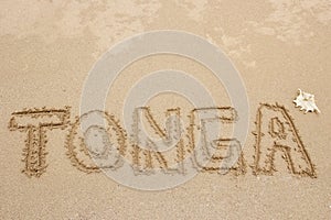 Word Tonga written in a sand