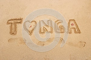 Word `Tonga` written in a sand