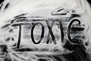 Word Toxic written in and with sugar, capital letters, health co photo