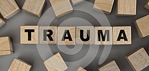 The word TRAUMA made from wooden cubes. Conceptual photo