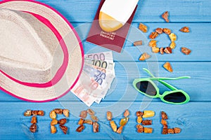 Word travel with shape of sun, sunglasses, sun lotion, straw hat, passport with currencies euro