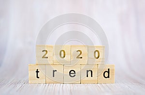 The word trend and 2020 on wooden cube block. 2020 trend concept