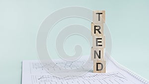 word trend with wood building blocks, light green background