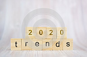 The word trends and 2020 on wooden cube block. 2020 trend concept