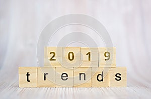 The word trends and 2019 on wooden cube block. 2019 trend concept