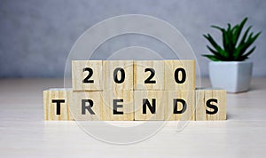 The word trends and 2020 on wooden cube block. 2020 trend concept photo