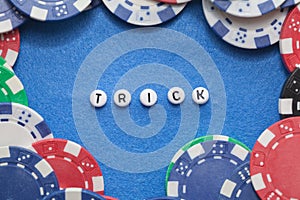 Word `trick` with poker chips