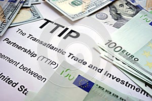 Word TTIP on a paper with dollars.
