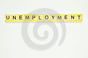 Word unemployment. Top view of wooden blocks with letters on white surface