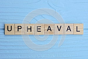 word upheaval made from wooden gray letters photo