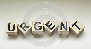 Word urgently on wooden cubes photo