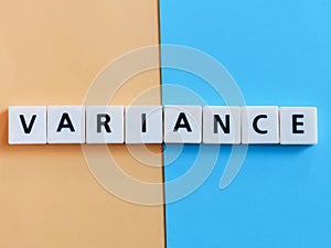 The word variance is composed of square letter tiles