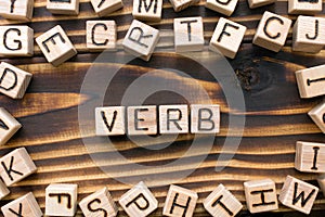 word verb composed of wooden cubes with letters