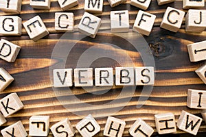 word verbs composed of wooden cubes with letters