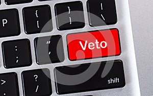 Word Veto written on red button of computer keyboard. photo