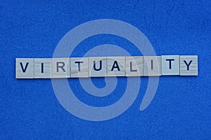 Word virtuality from gray small wooden letters with black font