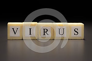 The word VIRUS written on wooden cubes isolated on a black background