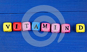 The word Vitamin D on a wood table
