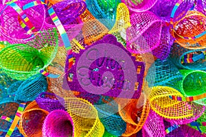 The word `viva fiesta` written in purple glitter on multicolored mash