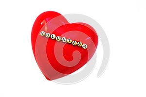 Word  Volunteer on red heart, White background