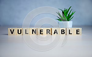 word Vulnerability on wooden cubes, concept background