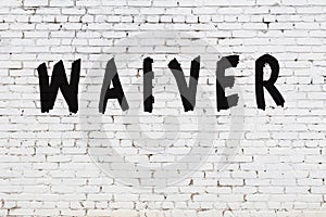 Word waiver painted on white brick wall photo