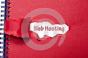 The word web hosting appearing behind torn paper