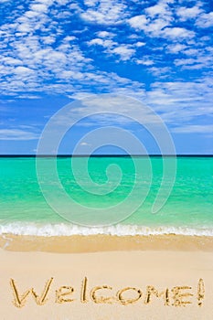 Word Welcome on beach