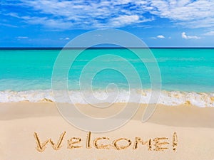 Word Welcome on beach