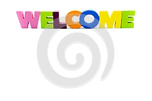 Word WELCOME written with colourful wooden letters, over white with copy space on the bottom