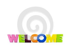 Word WELCOME written with colourful wooden letters, over white with copy space on the top