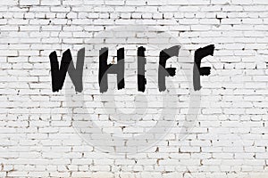 Word whiff painted on white brick wall