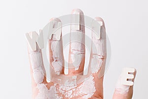 The word white on the fingers of a man over white background.