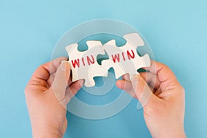 The word win is standing on puzzle parts, problem solving, winner mindset, business and education concept, coaching and motivation