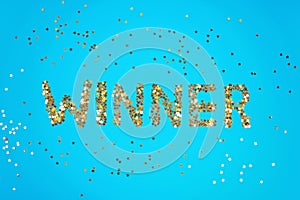 The word Winner is laid out of starry confetti on a blue background.