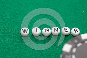 Word `winner` with poker chips and money