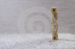 The word winter made of letters on wooden cubes on a snow background  5