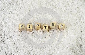 The word winter made of letters on wooden cubes on a snow background  3