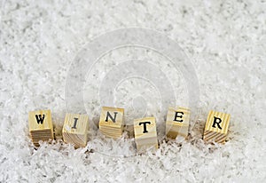 The word winter made of letters on wooden cubes on a snow background  2