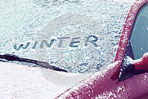 Word Winter written on a car windshield