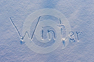The word Winter written on snow
