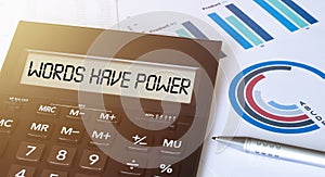 Word WORDS HAVE POWER on calculator. Business and finance concept