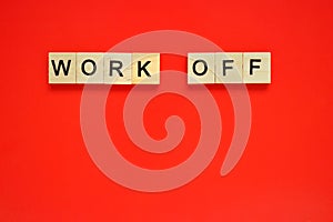 Word work off. Top view of wooden blocks with letters on red surface