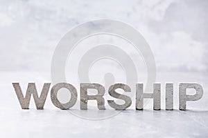 Word Worship made with cement letters on grey marble background. Copy space. Biblical, spiritual or christian reminder