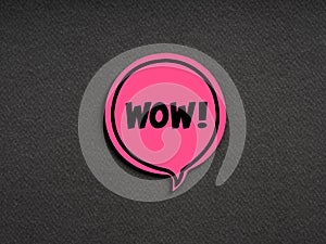 The word WOW on pink speech bubble on black background. Amazement, admiration, surprise or appreciation speech