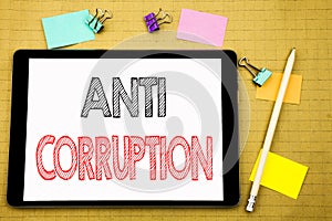 Word, writing Anti Corruption. Business concept for Bribery Corrupt Text Written on tablet laptop, wooden background with sticky n