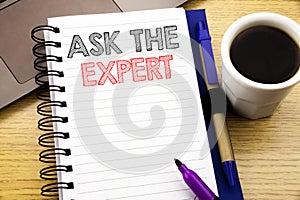 Word, writing Ask The Expert. Business concept for Advice Help Question written on notebook book on the wooden background in the O photo